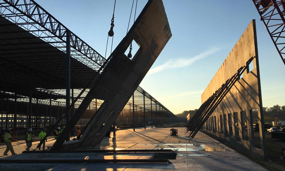 Penntex team members working on a construction site with walls being raised